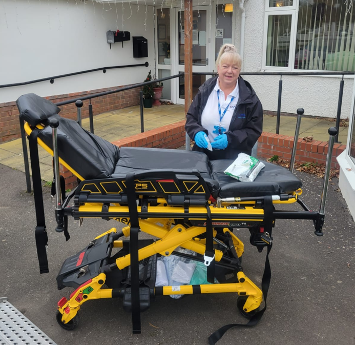 EMA Patient Transport ambulance crew, prepping a stretcher for a patient